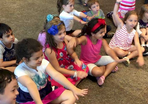Children sitting in a circle playing